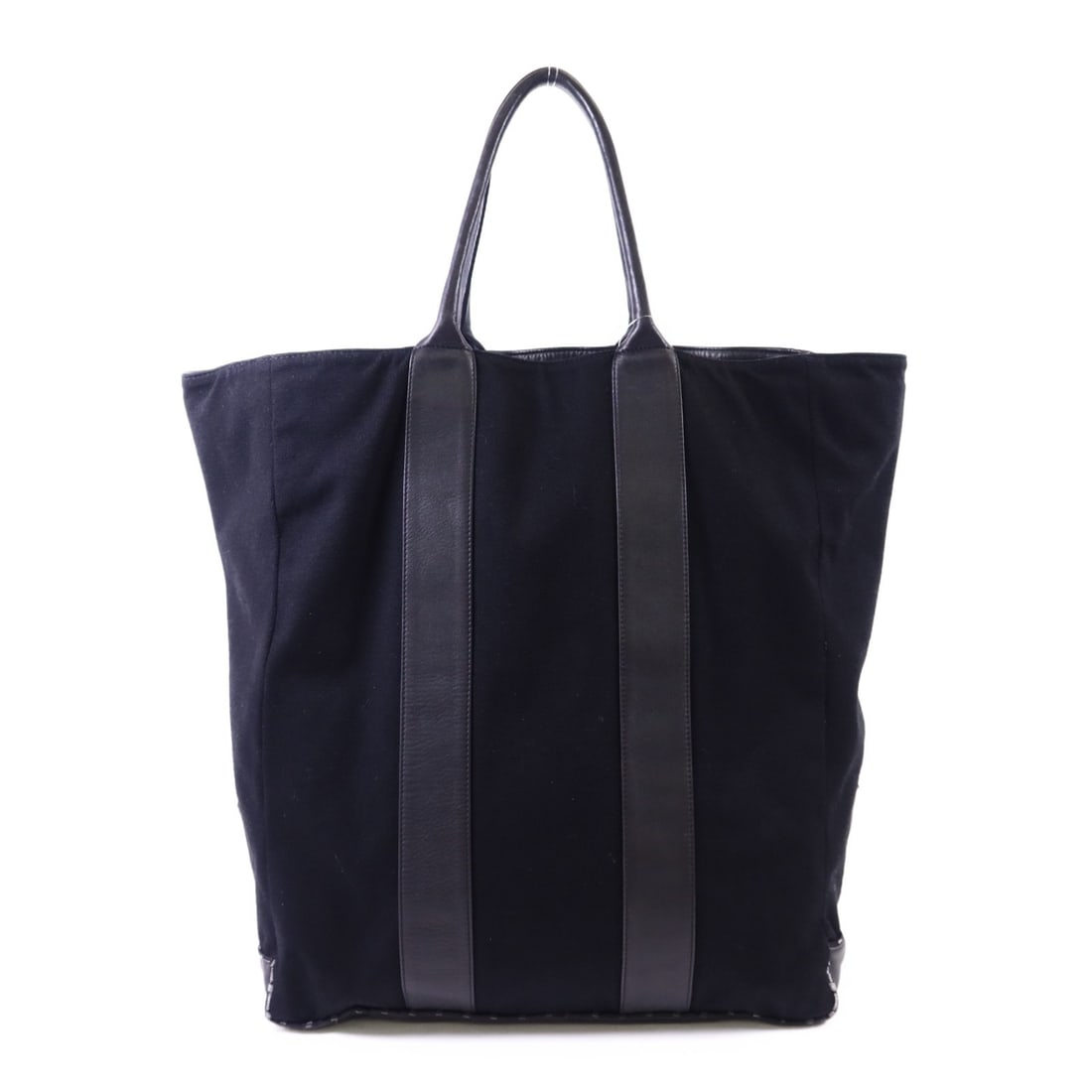 Black Canvas and Leather Tote with CC Logo by CHANEL: Black Canvas and Leather Tote with CC Logo by CHANEL This CHANEL CC tote bag features a black canvas exterior with leather accents. Designed in a regular size, the tote offers ample space and a classi