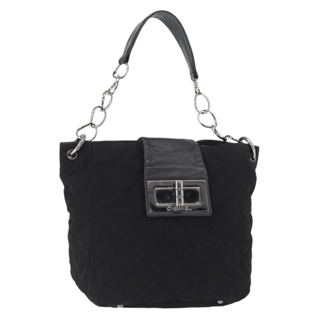 Black Nylon 2.55 Shoulder Bag by CHANEL with Silver Tone CC Hardware: Black Nylon 2.55 Shoulder Bag by CHANEL with Silver Tone CC Hardware This CHANEL 2.55 chain shoulder bag is crafted from black nylon with silver-tone accents. Designed with a classic silhouette, it fe