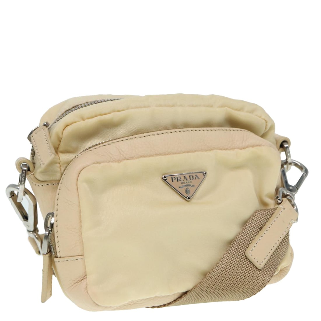 PRADA Beige Silver Nylon Pouch with Guarantee Card Italy: PRADA Beige Silver Nylon Pouch with Guarantee Card Italy This elegant PRADA Pouch is crafted from durable nylon in a sophisticated beige and silver color combination. Made in Italy, it features a comp