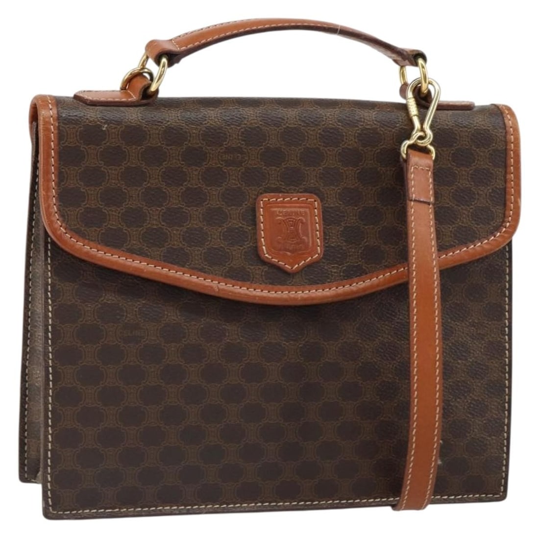 Celine Brown Macadam Canvas Two Way PVC Leather Handbag with Shoulder Strap: Celine Brown Macadam Canvas Two Way PVC Leather Handbag with Shoulder Strap This CELINE Macadam handbag features a brown and gold PVC leather and Macadam canvas exterior with gold-tone accents. Design