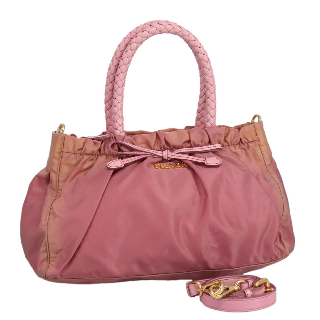PRADA Pink Gold Nylon 2-Way Hand Bag Authentic Italy 100093: PRADA Pink Gold Nylon 2-Way Hand Bag Authentic Italy 100093 This authentic PRADA hand bag showcases a stylish design crafted from durable nylon in a chic pink and gold color scheme. The bag measures a
