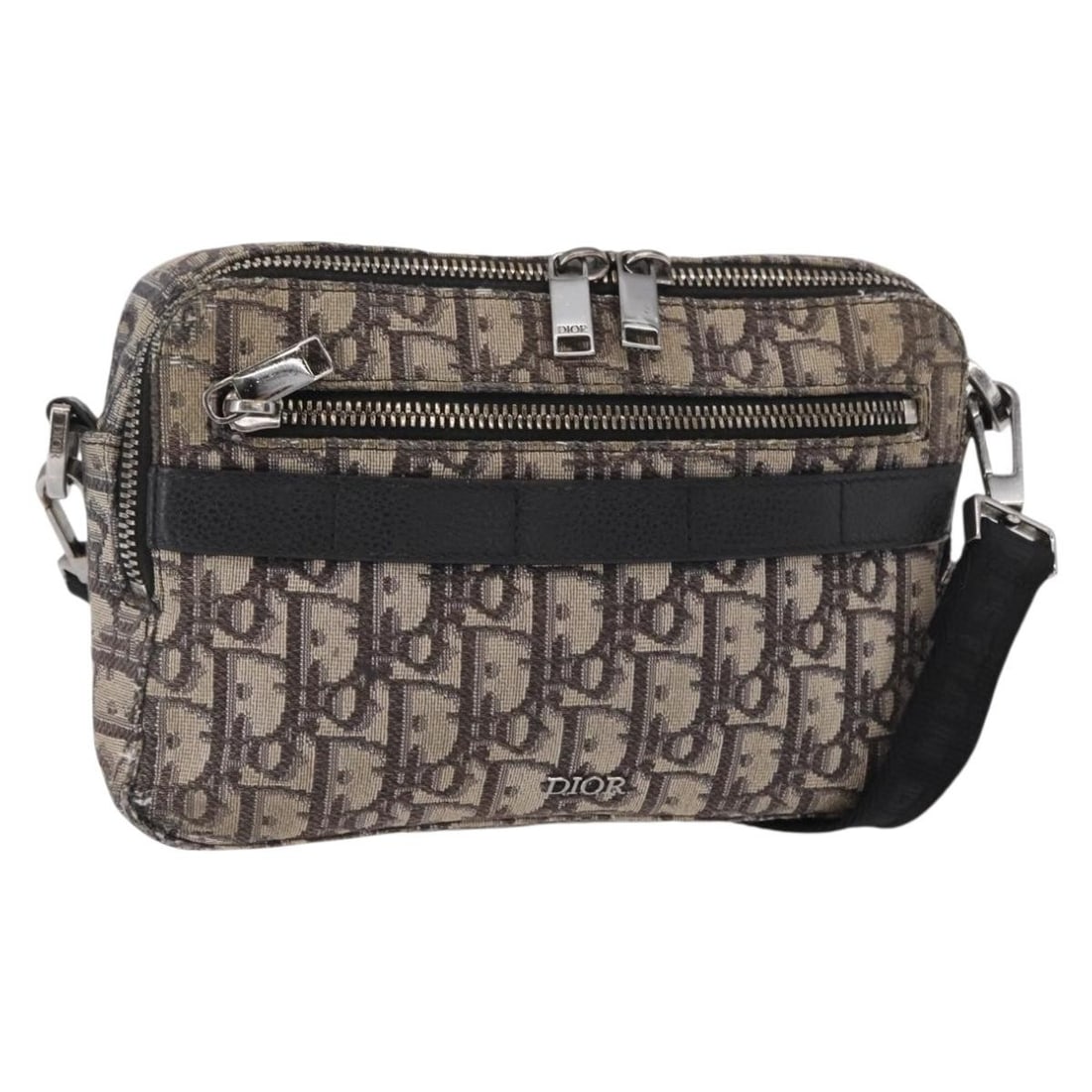 Black Oblique Trotter Canvas Shoulder Bag by Christian Dior Silver Details: Black Oblique Trotter Canvas Shoulder Bag by Christian Dior Silver Details This Christian Dior Trotter Canvas Oblique shoulder bag features a black and silver exterior crafted from the signature Trott