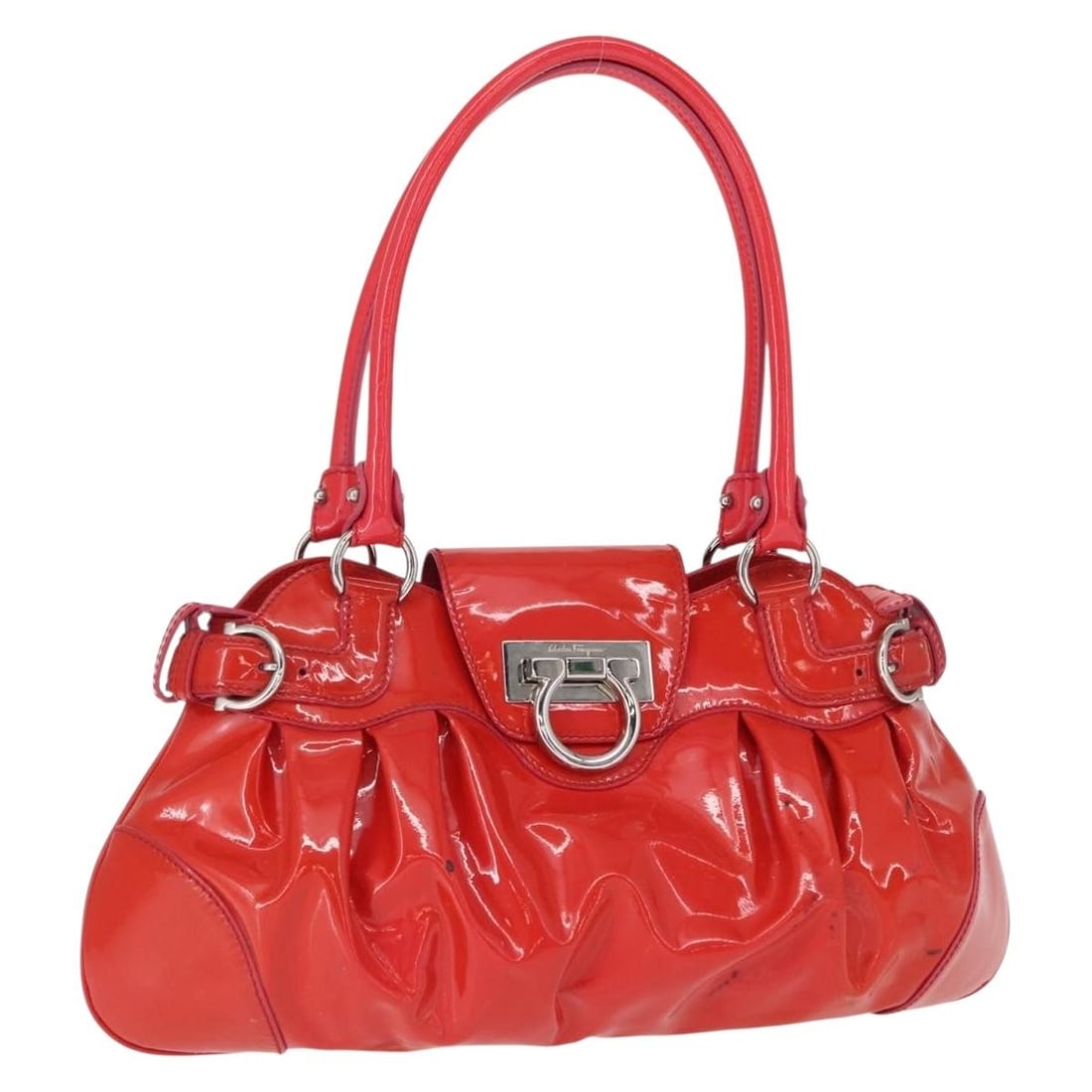 Red Enamel Gancini Handbag by Salvatore Ferragamo Silver Accents: Red Enamel Gancini Handbag by Salvatore Ferragamo Silver Accents This Salvatore Ferragamo Gancini handbag features a striking red and silver enamel exterior. Crafted in Italy, the bag measures approxi