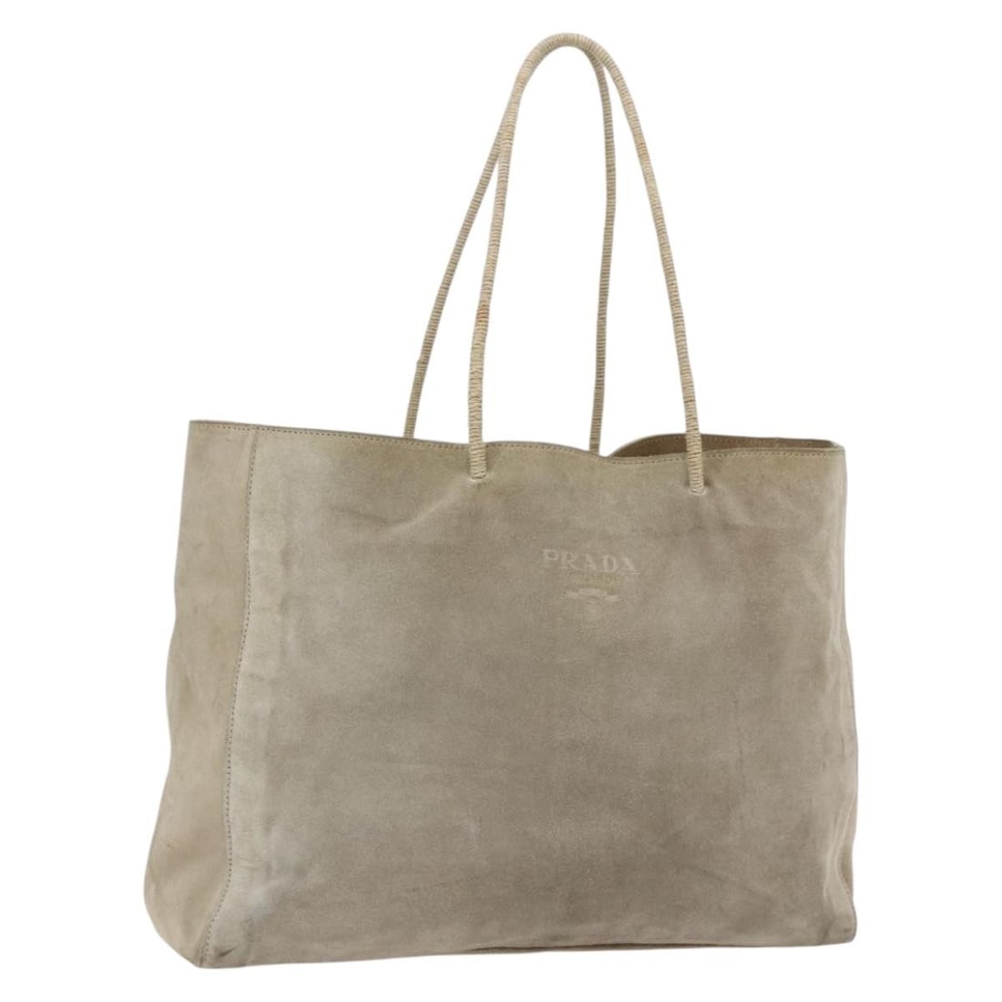 Beige Suede Tote by Prada Italy: Beige Suede Tote by Prada Italy This Prada tote bag is crafted from beige suede and features a spacious design. The bag shows notable signs of use, including surface rubbing, stains, and a loss of sha