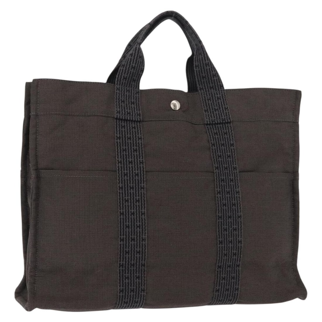 HERMES Her Line MM Gray Canvas Hand Bag Made in France: HERMES Her Line MM Gray Canvas Hand Bag Made in France This HERMES Her Line MM Hand Bag is a stylish canvas accessory in a sophisticated gray color. Crafted in France, it showcases a spacious design w