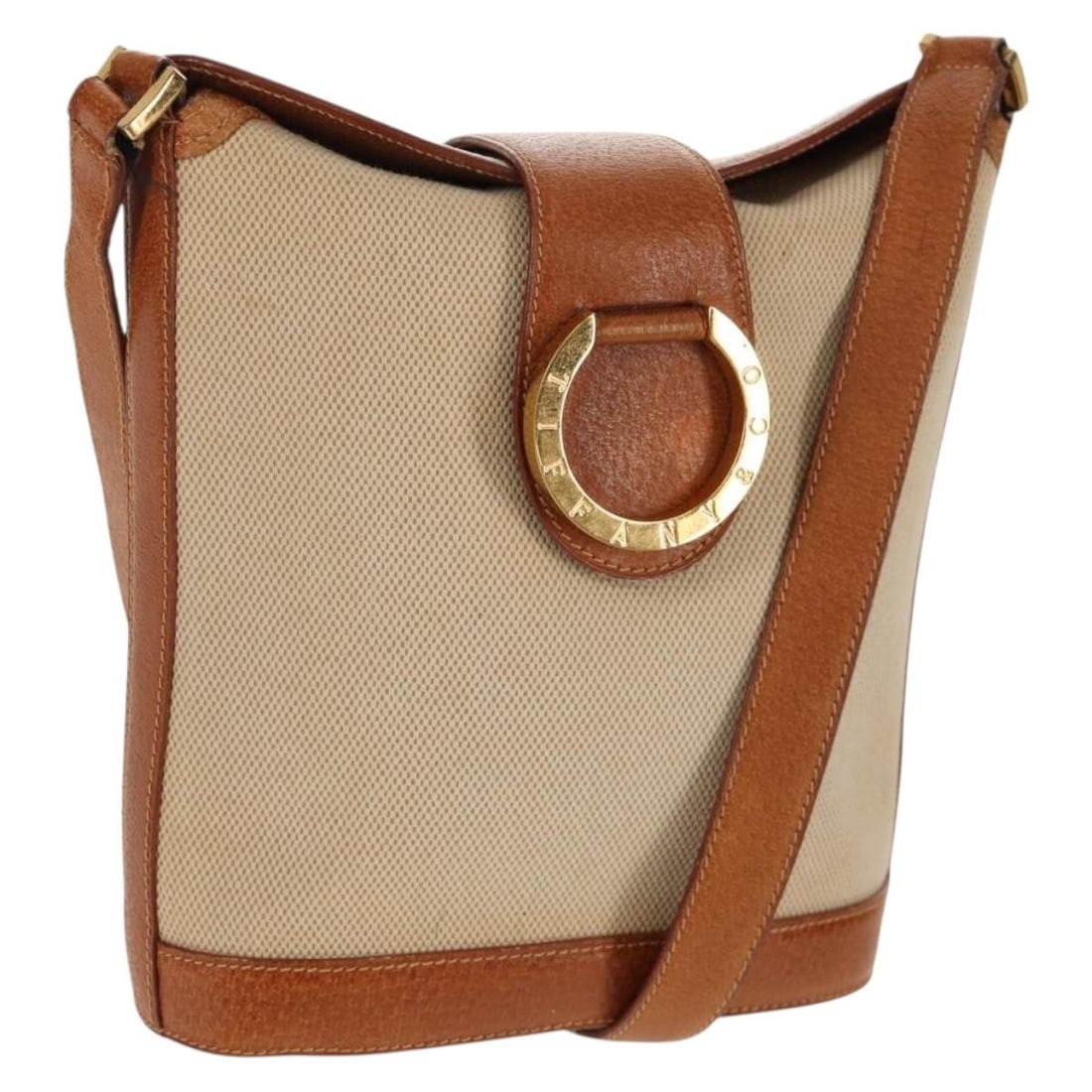 Beige and Gold Canvas Shoulder Bag by Tiffany and Co Italy: Beige and Gold Canvas Shoulder Bag by Tiffany and Co Italy This Tiffany & Co. shoulder bag is crafted from beige canvas with gold-toned accents. Made in Italy, it features a compact design suitable fo