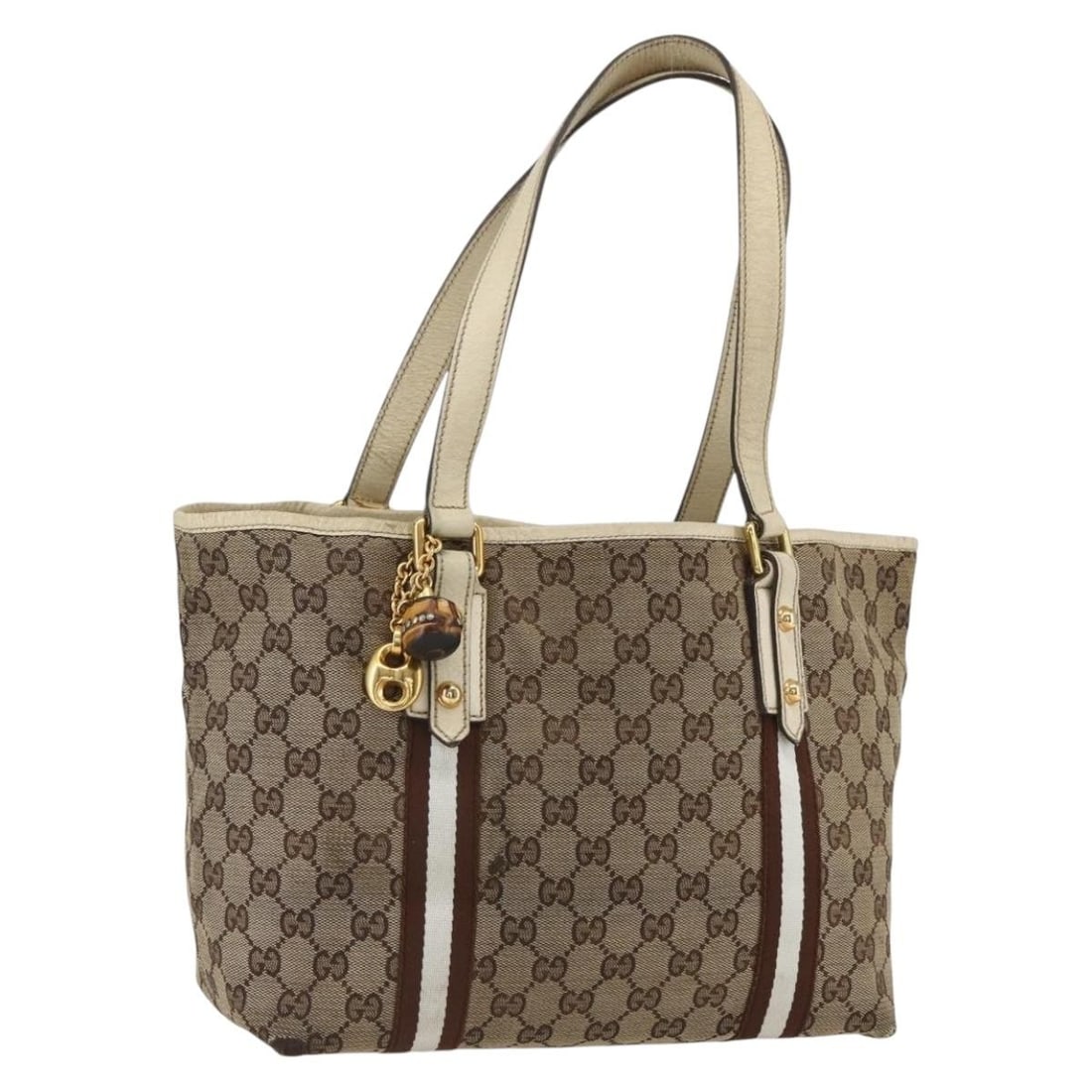 Beige GG Canvas Bamboo Handle Gucci 137396 Handbag with Gold Accents: Beige GG Canvas Bamboo Handle Gucci 137396 Handbag with Gold Accents This is a GUCCI GG Canvas Bamboo hand bag in beige and gold tones. The bag features the signature GG canvas material, bamboo handle
