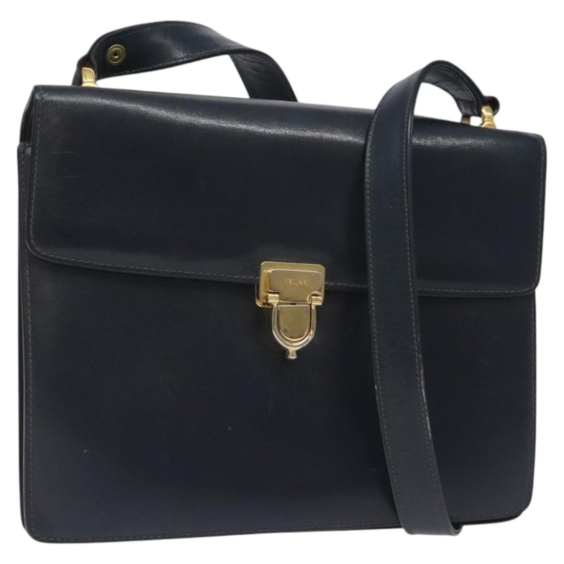 CELINE Navy Gold Leather Shoulder Bag Made in Italy: CELINE Navy Gold Leather Shoulder Bag Made in Italy This authentic CELINE shoulder bag is crafted from high-quality leather, showcasing a sleek navy exterior accented with gold details. With approxima