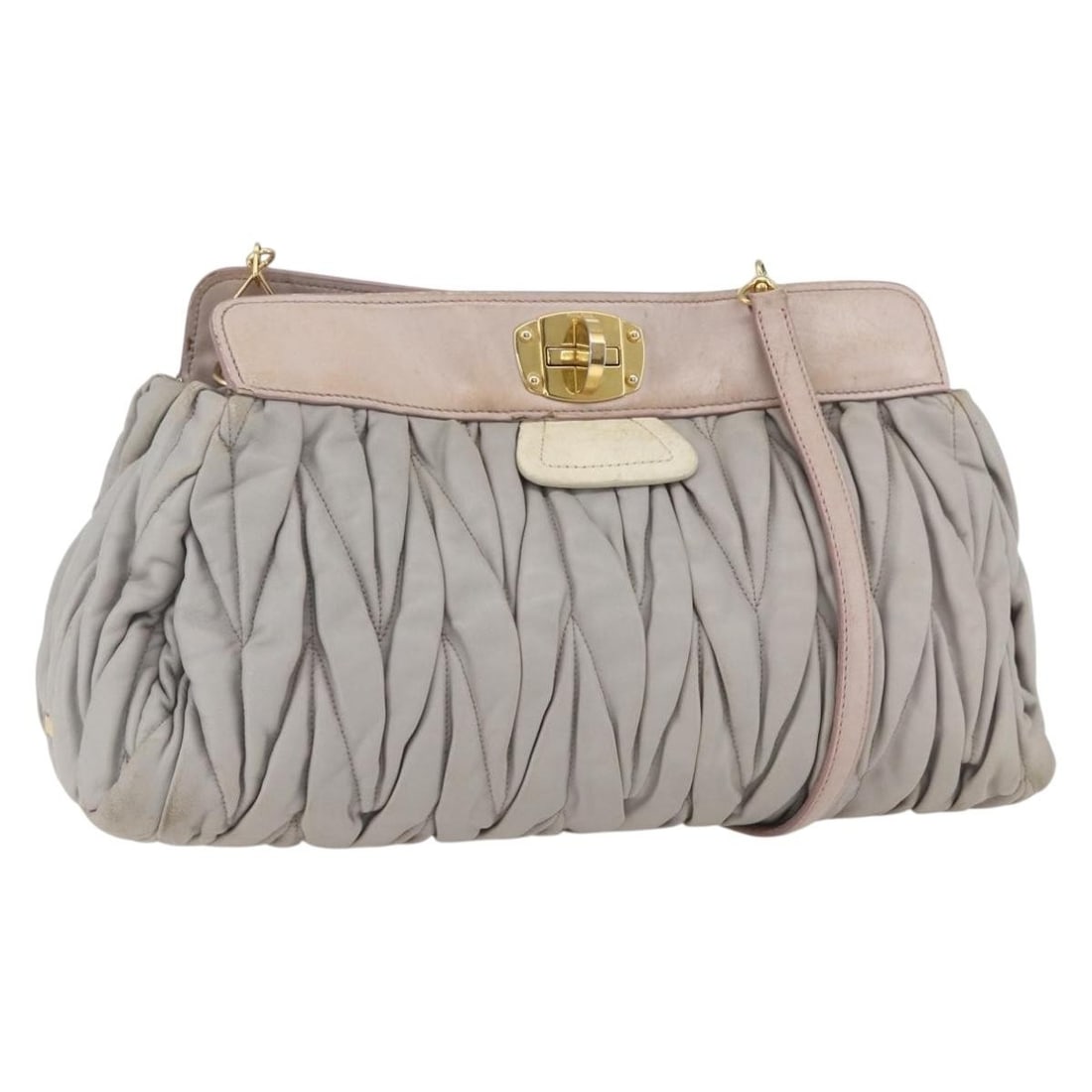 Gray Leather Miu Miu Matelasse Shoulder Bag with Gold Accents: Gray Leather Miu Miu Matelasse Shoulder Bag with Gold Accents This Miu Miu Matelasse shoulder bag features gray leather with gold-tone accents. Crafted in Turkey, the bag has a spacious interior and a