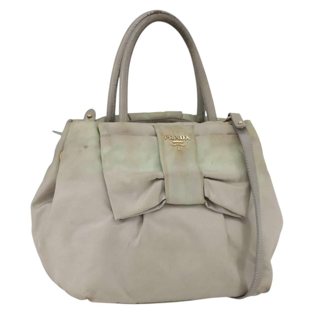 Ivory Gold Prada Nylon Convertible Handbag with Shoulder Strap: Ivory Gold Prada Nylon Convertible Handbag with Shoulder Strap This PRADA 2-way handbag is crafted from ivory nylon with gold-tone accents. The bag features both a handle and a detachable shoulder str