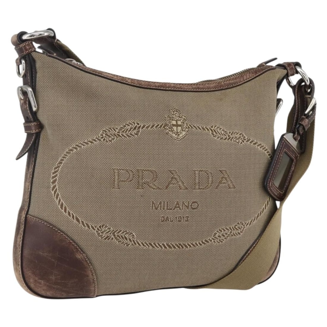 Prada Beige Canvas Shoulder Purse with Silver Accents from Italy: Prada Beige Canvas Shoulder Purse with Silver Accents from Italy This PRADA shoulder bag features a beige and silver canvas exterior. Made in Italy, it is designed with an adjustable strap drop and of