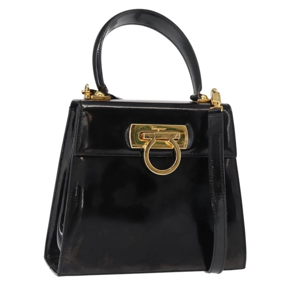 Black Patent Leather Gancini Handbag by Salvatore Ferragamo with Shoulder Strap: Black Patent Leather Gancini Handbag by Salvatore Ferragamo with Shoulder Strap This Salvatore Ferragamo Gancini 2-way handbag features black patent leather with gold-tone accents. Designed for versat