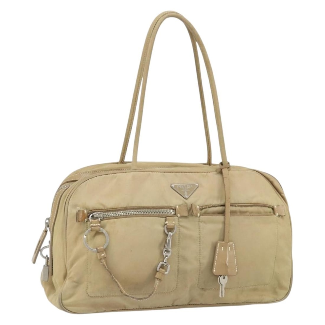 Beige Nylon Prada Handbag with Silver Accents and Accessories: Beige Nylon Prada Handbag with Silver Accents and Accessories This Prada hand bag features a beige nylon exterior with silver-tone accents. The bag has a structured silhouette with approximate dimensi