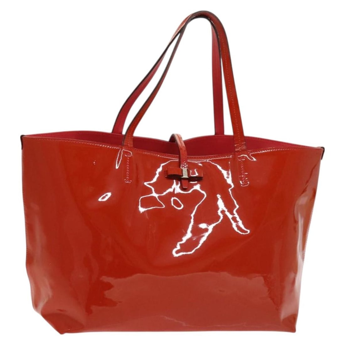 Red Enamel Vala Tote by Salvatore Ferragamo Italy: Red Enamel Vala Tote by Salvatore Ferragamo Italy This Salvatore Ferragamo Vala tote bag features a striking red enamel exterior with a classic tote silhouette. Made in Italy, it offers a spacious int