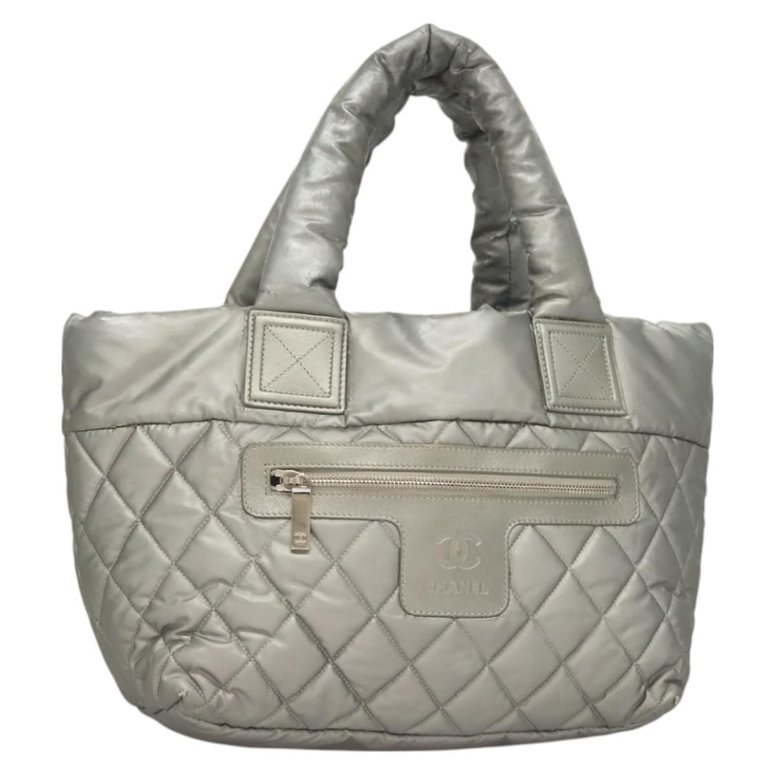 Gray Silver Nylon Tote Cococoon Collection by CHANEL with Guarantee Card: Gray Silver Nylon Tote Cococoon Collection by CHANEL with Guarantee Card This CHANEL Cococoon tote bag features a gray and silver nylon exterior with signature CC accents. Designed in Italy, it offers