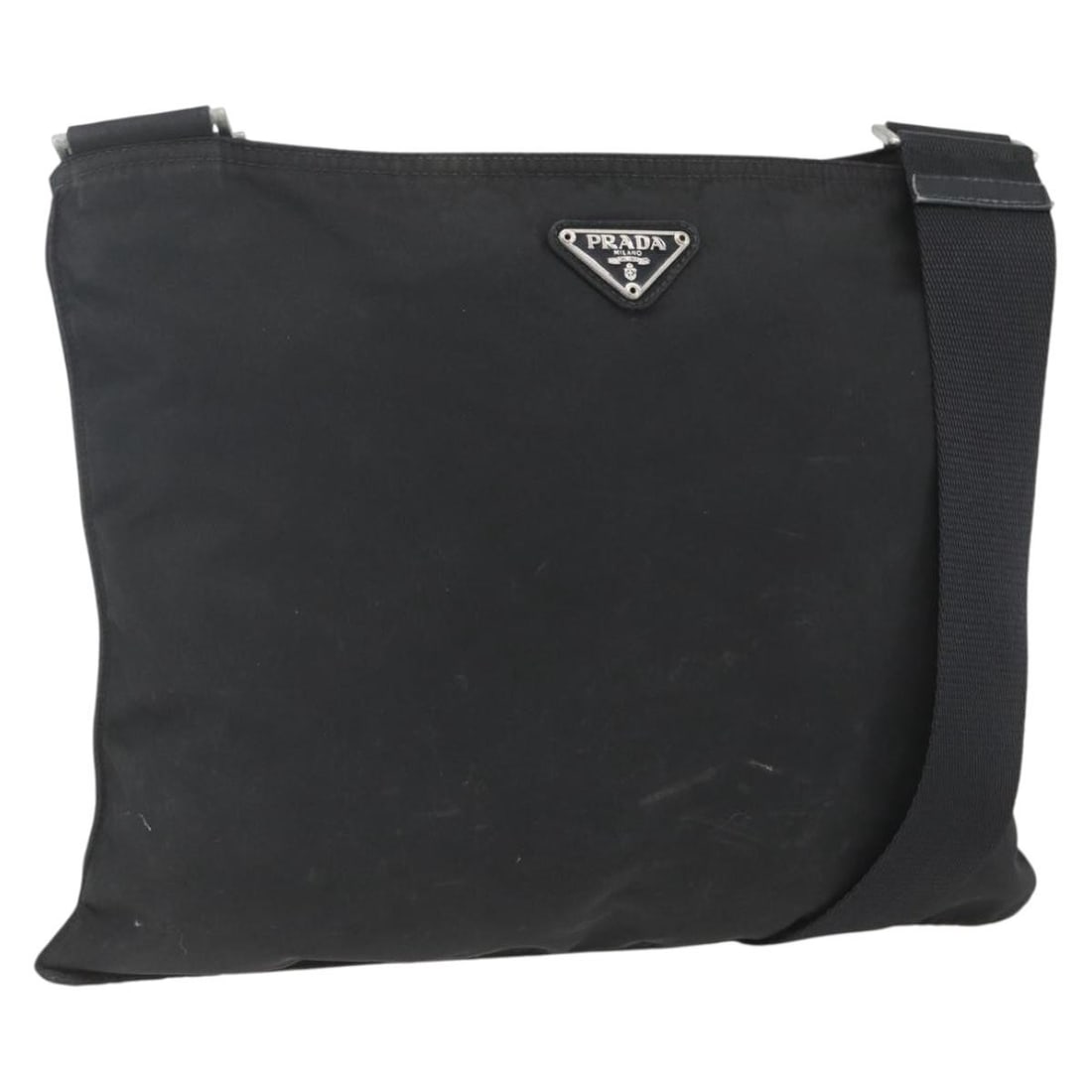 Black Nylon Prada Shoulder Bag with Silver Tone Details Italy: Black Nylon Prada Shoulder Bag with Silver Tone Details Italy This PRADA shoulder bag is crafted from black nylon with silver-tone accents. Made in Italy, the bag features an adjustable shoulder strap