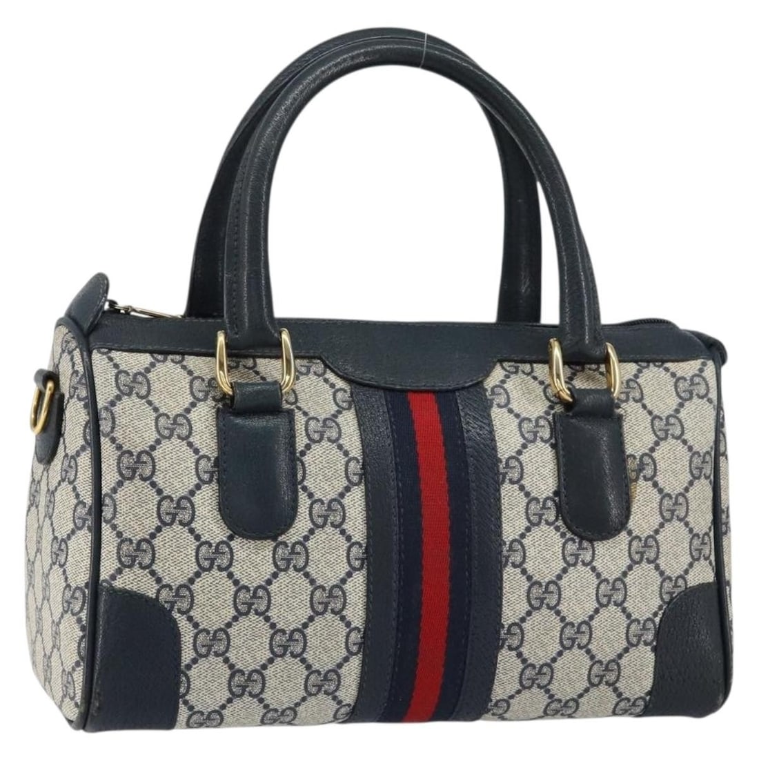 Boston Bag in Navy GG Supreme PVC by Gucci Sherry Line 002 39 0069: Boston Bag in Navy GG Supreme PVC by Gucci Sherry Line 002 39 0069 This is a Gucci GG Supreme Sherry Line Boston Bag crafted from navy and gold PVC leather with GG canvas accents. The bag features dua