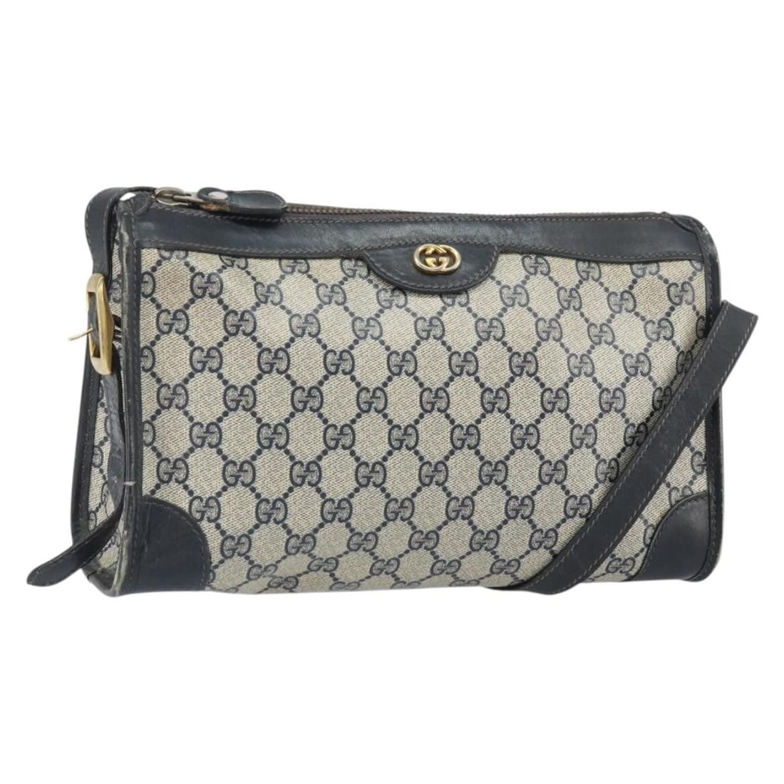 Navy GG Supreme Shoulder Bag by Gucci in PVC and Leather: Navy GG Supreme Shoulder Bag by Gucci in PVC and Leather This GUCCI GG Supreme shoulder bag features a navy and gold color scheme and is crafted from PVC leather with GG canvas accents. Designed as a