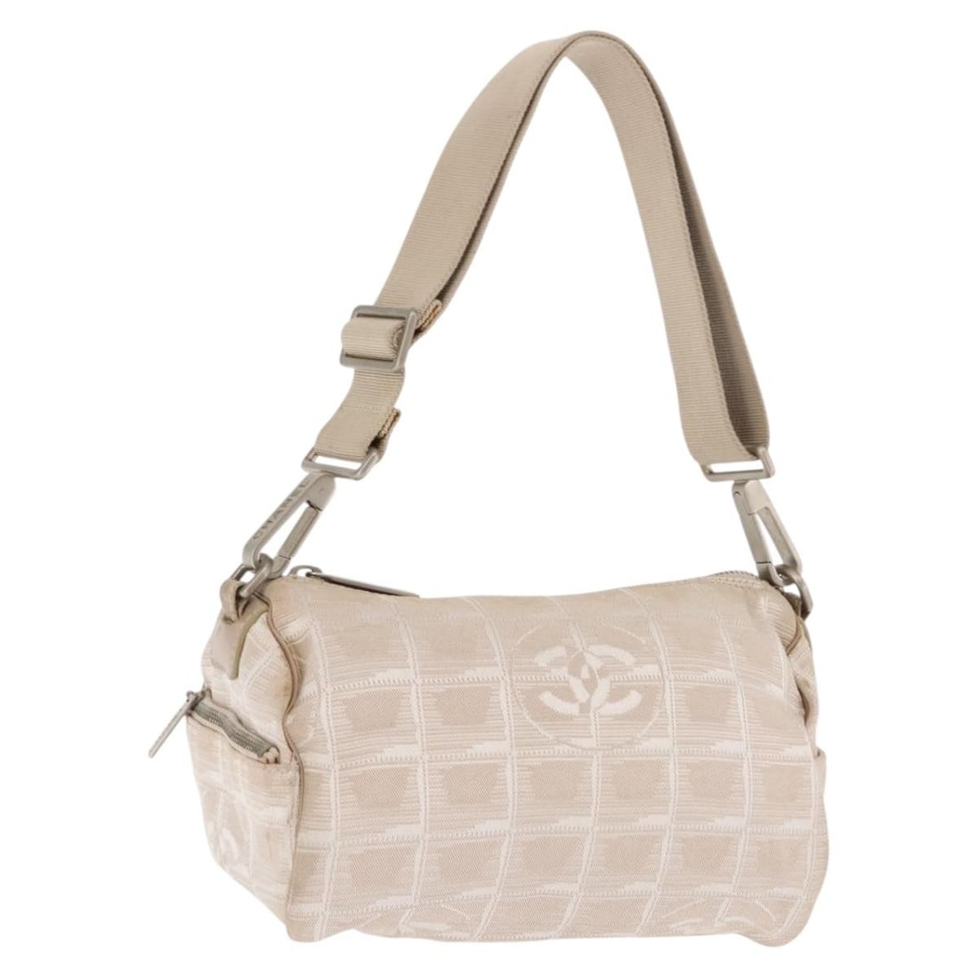 Beige Nylon Shoulder Bag by CHANEL New Travel Line with CC Logo: Beige Nylon Shoulder Bag by CHANEL New Travel Line with CC Logo This CHANEL Travel Line shoulder bag is crafted from beige nylon and features the iconic CC logo. Designed for practicality and style, i