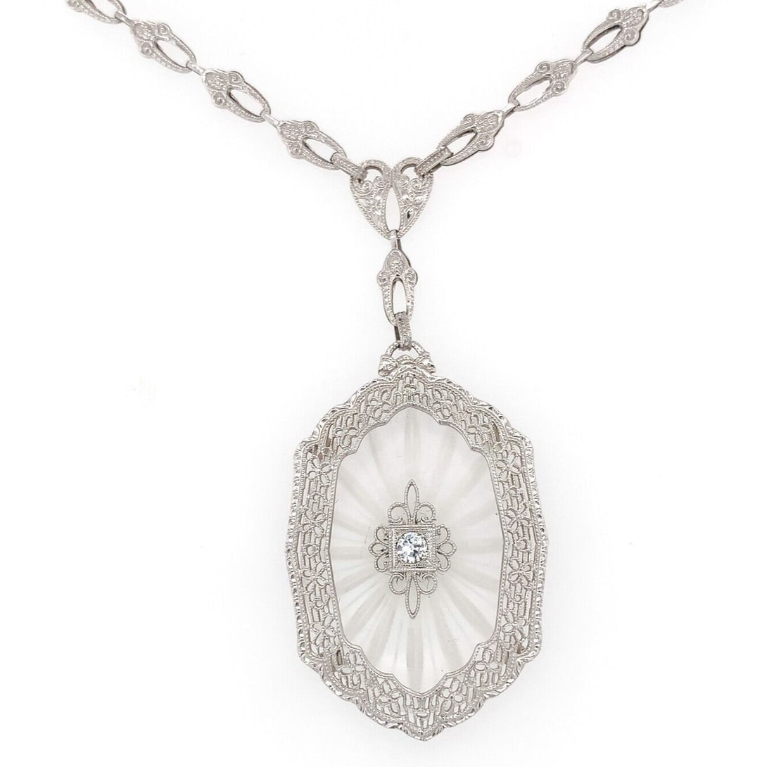 Art Deco 14k White Gold Filigree Rock Crystal Diamond Necklace: Art Deco 14k White Gold Filigree Rock Crystal Diamond Necklace This exquisite Art Deco necklace features a stunning 14k white gold filigree design, showcasing a large, beautifully frosted and reverse