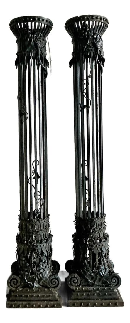 Pair of Tall Black Wrought Iron Neoclassical Architectural Columns: Pair of Tall Black Wrought Iron Neoclassical Architectural Columns This pair of vintage Neoclassical wrought iron columns features a dramatic open-work design with vertical iron rods reminiscent of fl