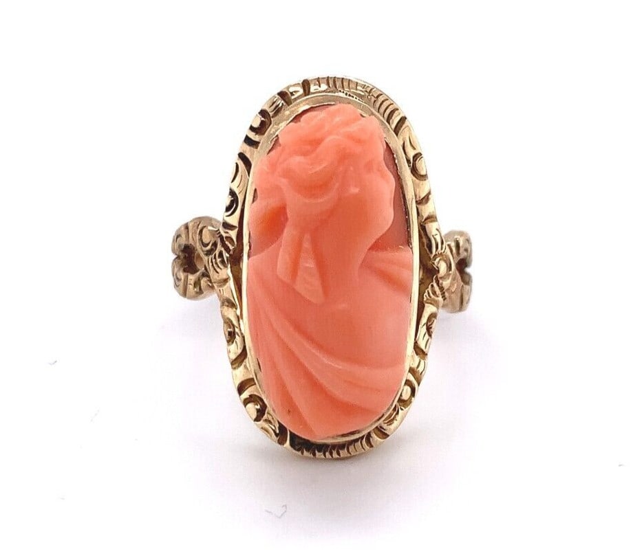 Victorian Era 14K Yellow Gold Ring With Natural Coral Cameo Size 5.75: Victorian Era 14K Yellow Gold Ring With Natural Coral Cameo Size 5.75 This Victorian era ring features a genuine natural coral cameo set in 14K yellow gold. The lighter coral cameo measures approximat