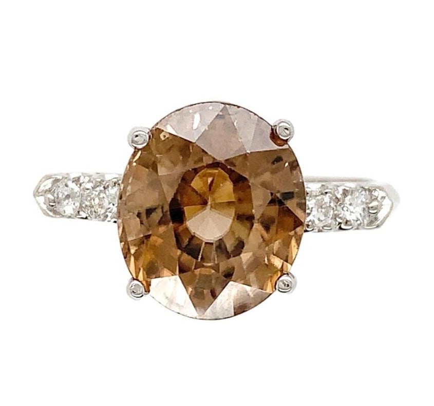 1940s Platinum 6.37 Carat Champagne Zircon Diamond Ring: 1940s Platinum 6.37 Carat Champagne Zircon Diamond Ring This stunning vintage ring features a 6.37 carat oval brilliant cut zircon in a captivating champagne/light brown hue, measuring approximately 1