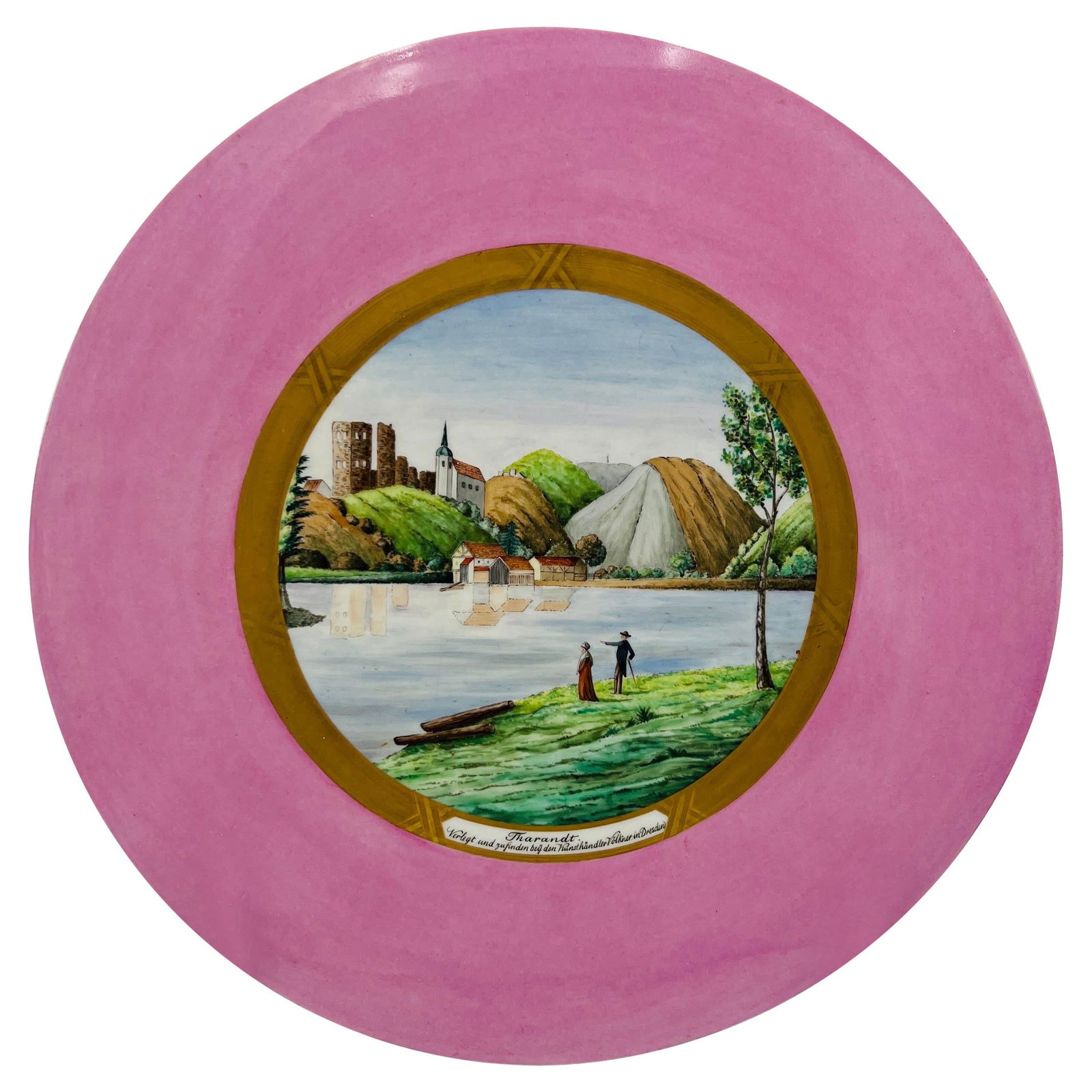 KPM Porcelain Plaque View of Tharandt Early 20th Century: KPM Porcelain Plaque View of Tharandt Early 20th Century This exquisite antique KPM porcelain plaque features a stunning countryside painting of Tharandt, set against a pink body. Accentuated by a gil