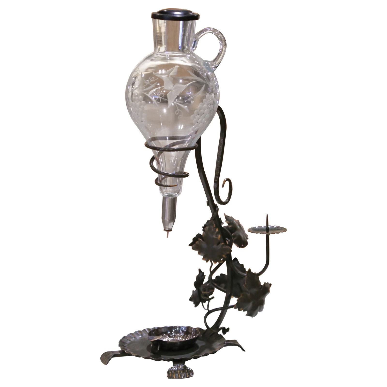 French Blown Glass Wine Dispenser on Wrought Iron Stand with Tastevin Cup: French Blown Glass Wine Dispenser on Wrought Iron Stand with Tastevin Cup This mid-century French wine decanter dispenser features a hand-blown glass decanter, etched with grapevine and leaf motifs, s