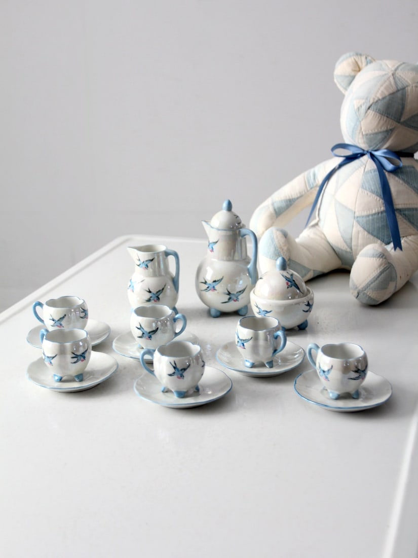 Antique Miniature German Porcelain Tea Set with Blue Birds: Antique Miniature German Porcelain Tea Set with Blue Birds This charming antique miniature tea set, crafted in early 20th century Germany, features delicate iridescent white porcelain adorned with lov