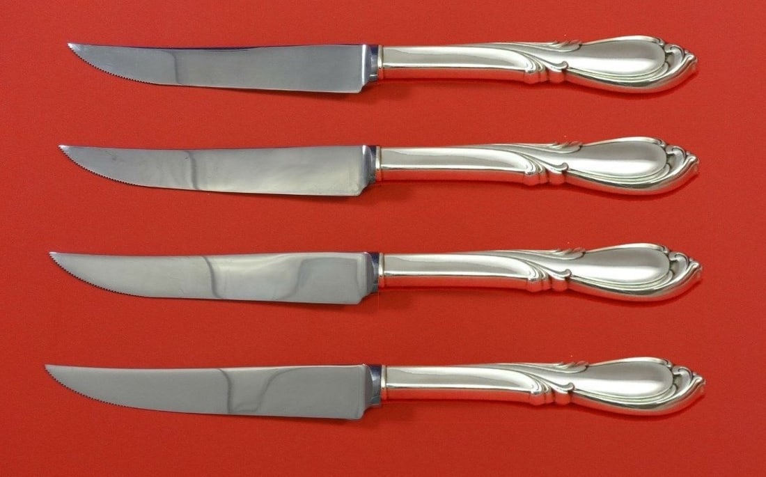 International Sterling Silver Rhapsody New Steak Knife Set 4pc Custom: International Sterling Silver Rhapsody New Steak Knife Set 4pc Custom Enhance your dining experience with this exquisite Rhapsody New steak knife set by International. Crafted from sterling silver wit