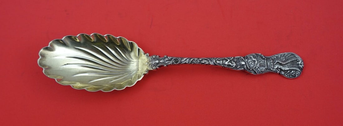Durgin Heraldic Sterling Silver Berry Spoon Gold Washed 9": Durgin Heraldic Sterling Silver Berry Spoon Gold Washed 9" This stunning serving spoon is a Heraldic Berry Spoon by Durgin, crafted from high-quality sterling silver. The piece features a narrow swirl