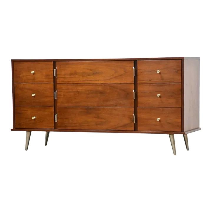 1960s Mid Century Walnut Dresser with Chrome Brass Hardware: 1960s Mid Century Walnut Dresser with Chrome Brass Hardware This mid-century modern dresser features a refined walnut finish and includes nine spacious drawers for ample storage. The dresser is adorne