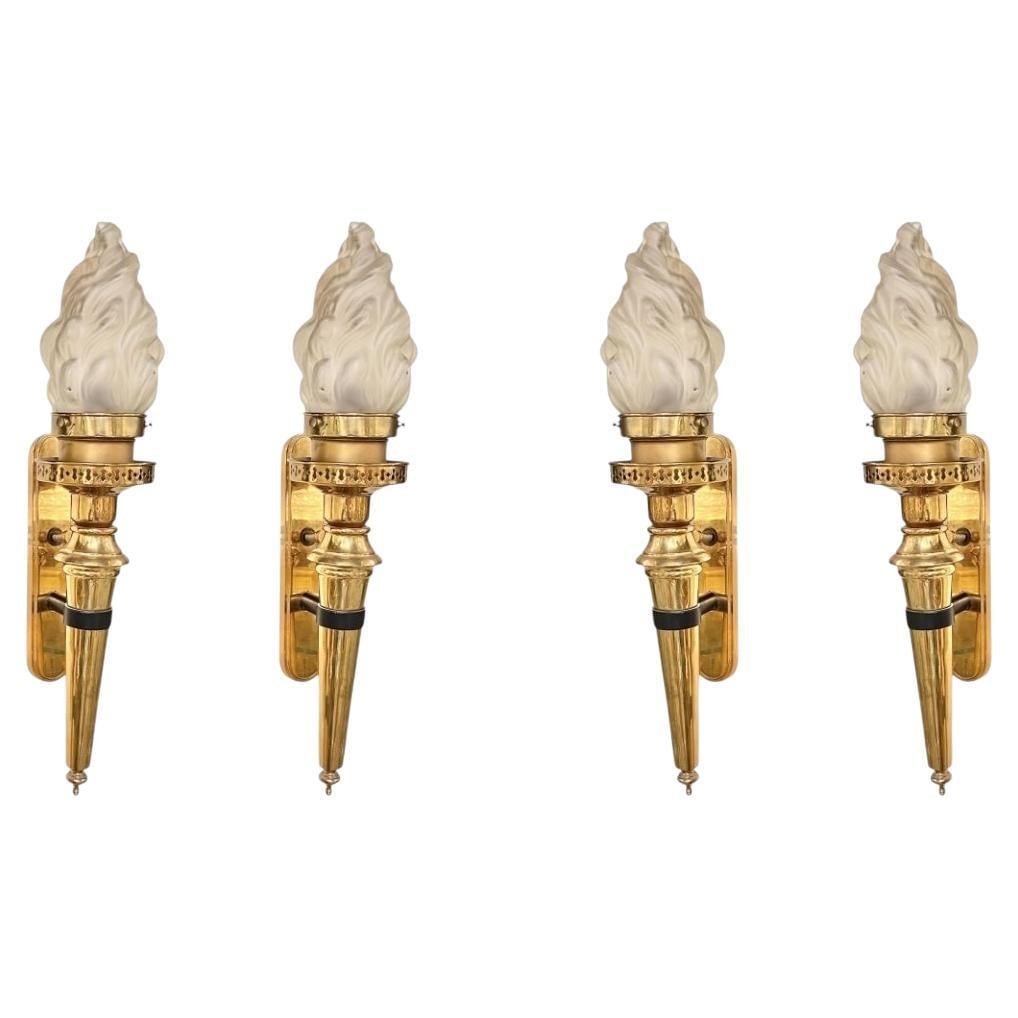Set of 4 Brass Torch Wall Sconces with Frosted Flame Glass Shades: Set of 4 Brass Torch Wall Sconces with Frosted Flame Glass Shades This set includes four antique wall sconces featuring a flaming torch design in polished brass. Each sconce is fitted with a large 7-i