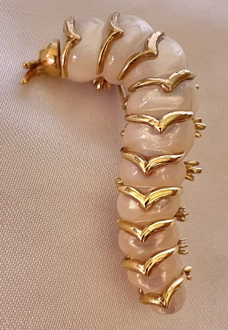 Robert Wander 14K Gold Caterpillar Brooch with Mother of Pearl: Robert Wander 14K Gold Caterpillar Brooch with Mother of Pearl Discover the exquisite craftsmanship of this 14K yellow gold brooch featuring a delightful caterpillar design, accented with mother of pe