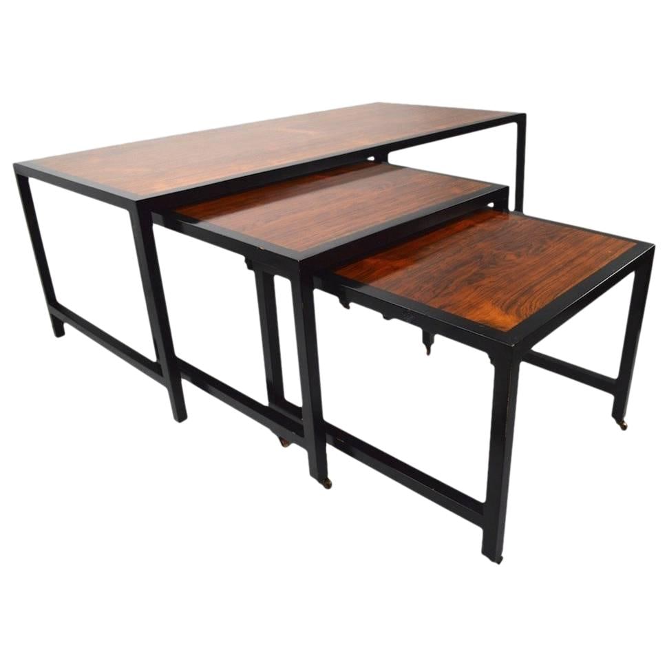 Harvey Probber Rosewood Three-Piece Nesting Tables with Brass Wheels: Harvey Probber Rosewood Three-Piece Nesting Tables with Brass Wheels This elegant three-piece nesting table set, attributed to Harvey Probber, features a stunning architectural design. The tables boas