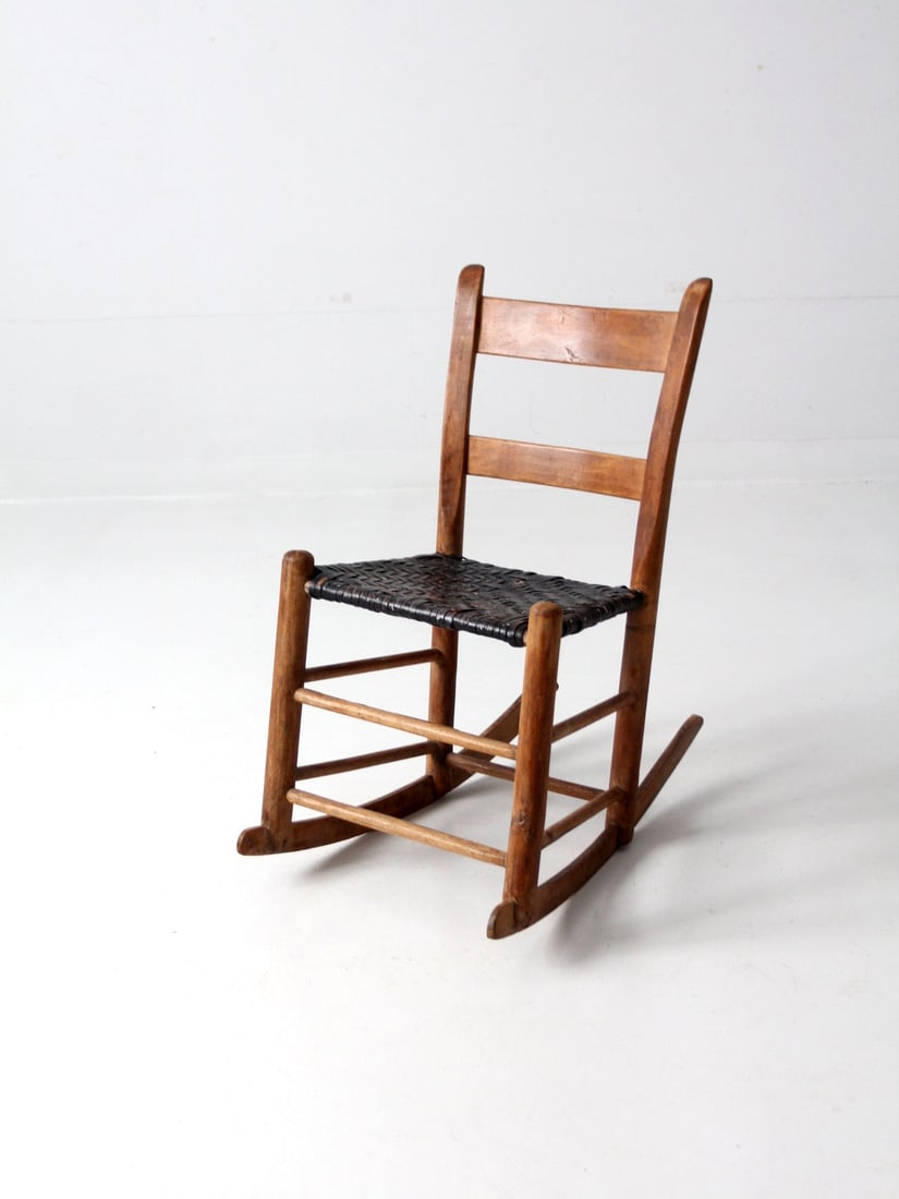 Antique Children's Rocking Chair with Black Splint Weave Seat: Antique Children's Rocking Chair with Black Splint Weave Seat This charming antique children's rocking chair features a classic ladder back design and a beautifully crafted black splint weave seat ado