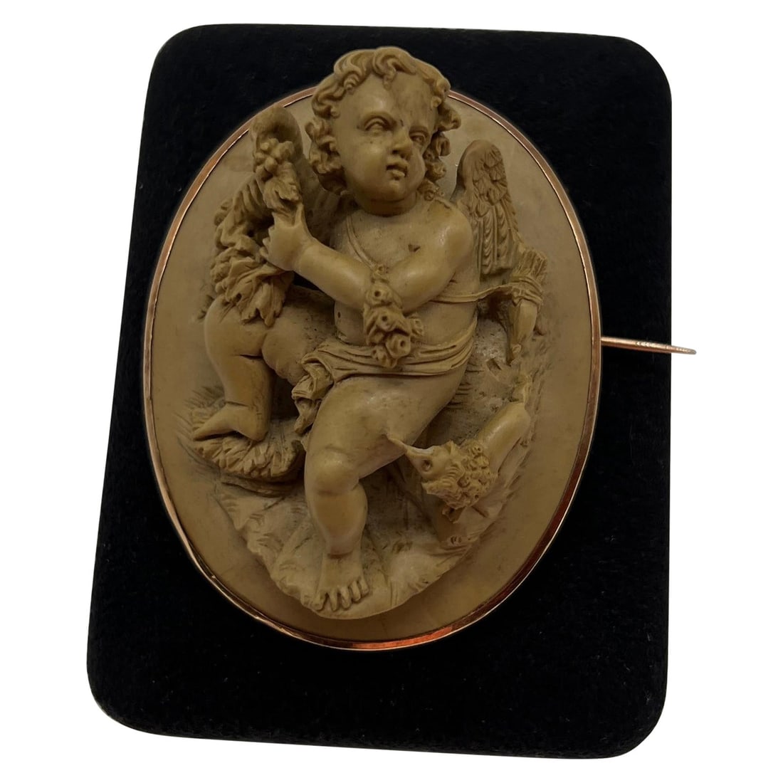 Victorian 18K Gold Lava Stone Putti Dog Brooch Italy 19th Century: Victorian 18K Gold Lava Stone Putti Dog Brooch Italy 19th Century This exquisite Victorian brooch showcases a high relief carved lava stone featuring a central putti figure elegantly adorned with grap