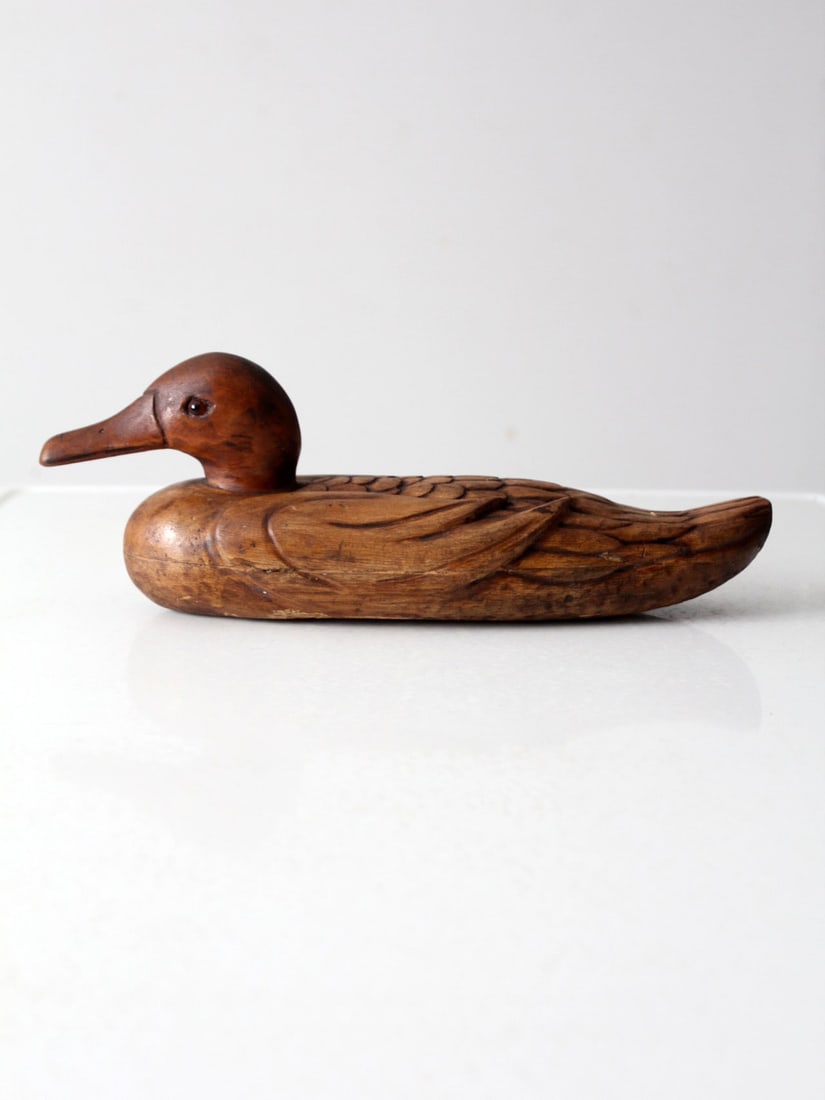 Harold Dickman Vintage Hand Carved Wooden Duck Decoy 14 Inch: Harold Dickman Vintage Hand Carved Wooden Duck Decoy 14 Inch This vintage hand-carved wooden duck decoy is a stunning display of craftsmanship, featuring intricate feather detailing and lifelike glass