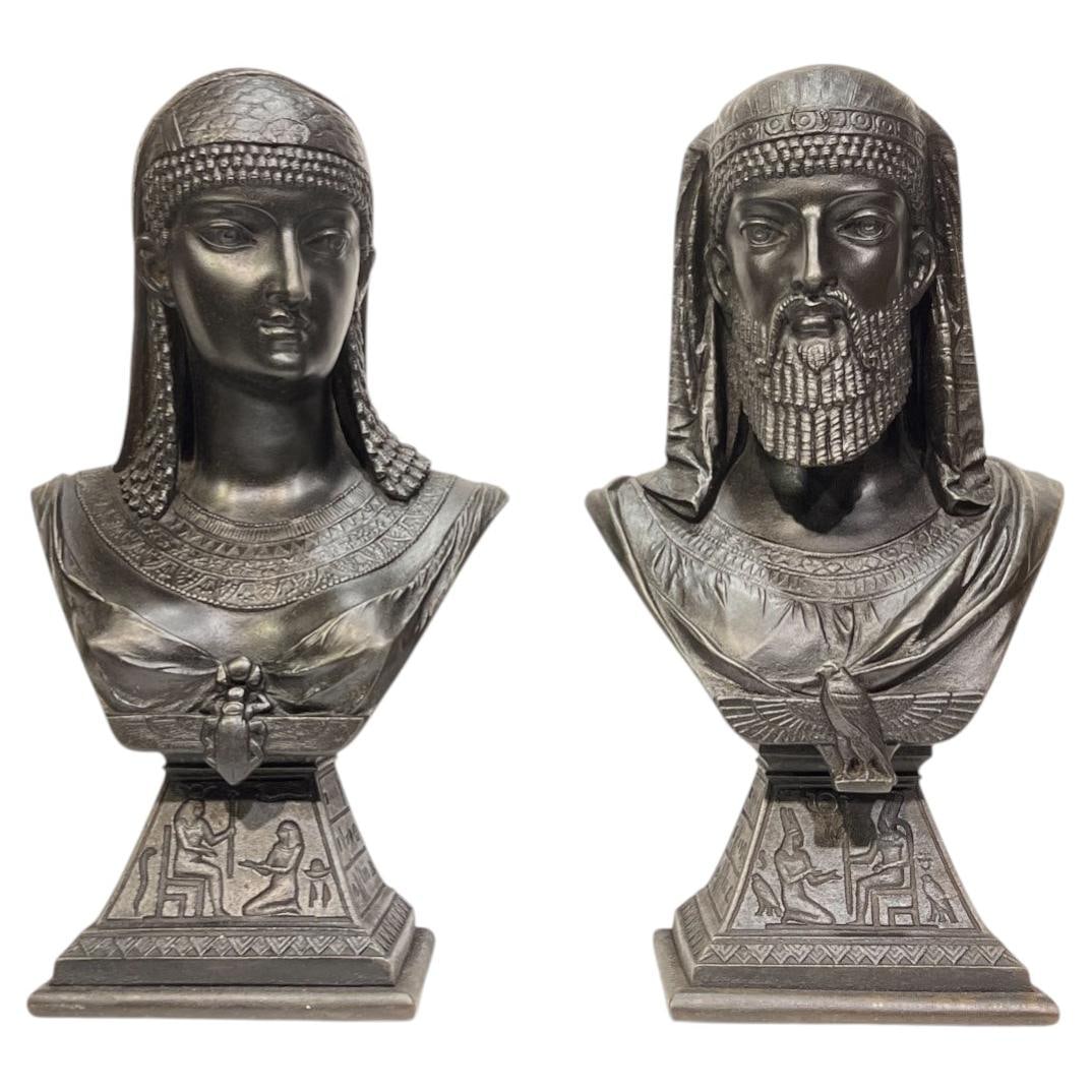 Set of 2 Egyptian Revival Metal Busts After J Guillot 1876: Set of 2 Egyptian Revival Metal Busts After J Guillot 1876 This set features two Egyptian Revival busts depicting a king and queen, crafted from patinated spelter metal. The pieces are modeled after t