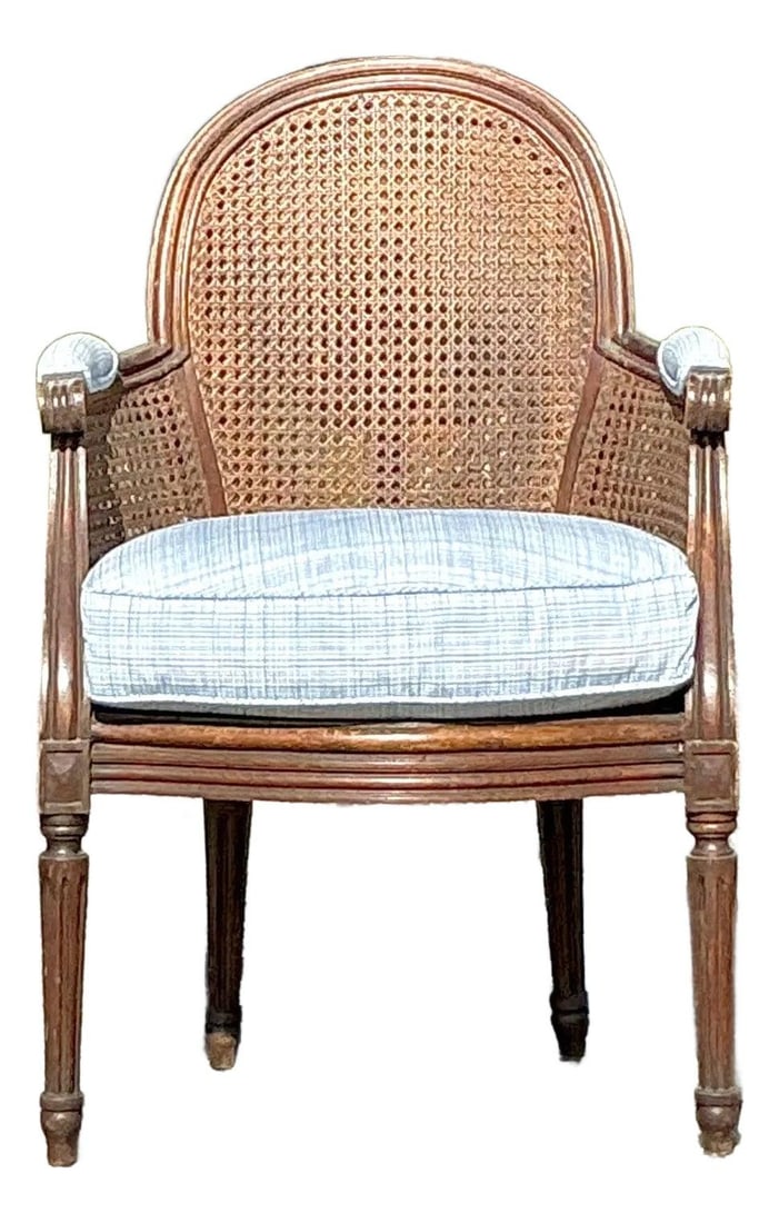 Vintage Regency Cane Bergere Chair with Plaid Cushion: Vintage Regency Cane Bergere Chair with Plaid Cushion Elevate your living space with this stunning Vintage Regency Cane Fireside Bergere Chair. Crafted with a hand-carved wooden frame showcasing elega