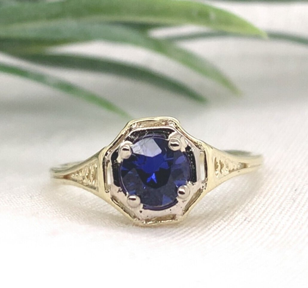 Vintage 14k Gold Filigree Ring with .55ct Round Purple Sapphire Size 5.5: Vintage 14k Gold Filigree Ring with .55ct Round Purple Sapphire Size 5.5 This rare filigree ring is crafted in 14k yellow gold and features a genuine, natural round-cut purple sapphire weighing 0.55 c