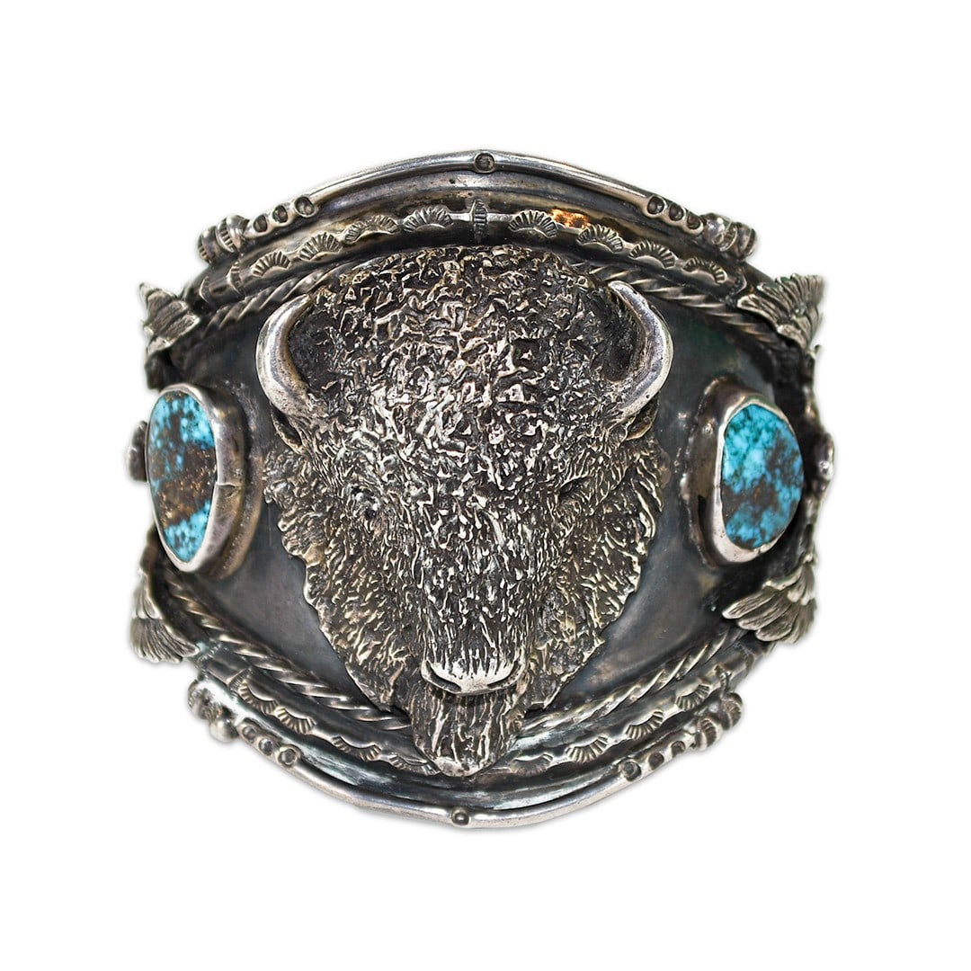 6.65ozt Sterling Silver Bangle Bracelet With Natural Turquoise Buffalo Motif: 6.65ozt Sterling Silver Bangle Bracelet With Natural Turquoise Buffalo Motif This custom-made bangle bracelet features genuine turquoise stones on the sides and a striking buffalo motif. Crafted from