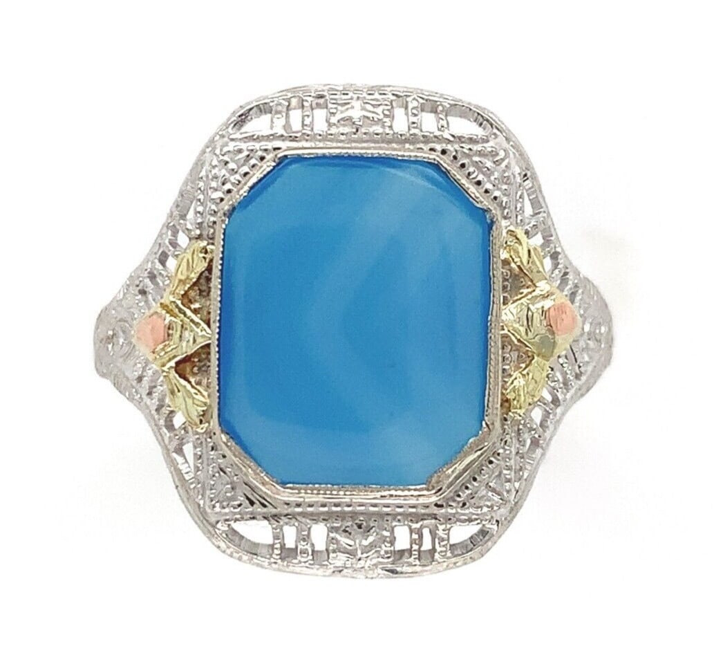 10k White Gold Filigree Blue Onyx Ring with Gold Accents: 10k White Gold Filigree Blue Onyx Ring with Gold Accents This exquisite 10k white gold filigree ring showcases a genuine natural blue onyx centerpiece, beautifully complemented by delicate green and p