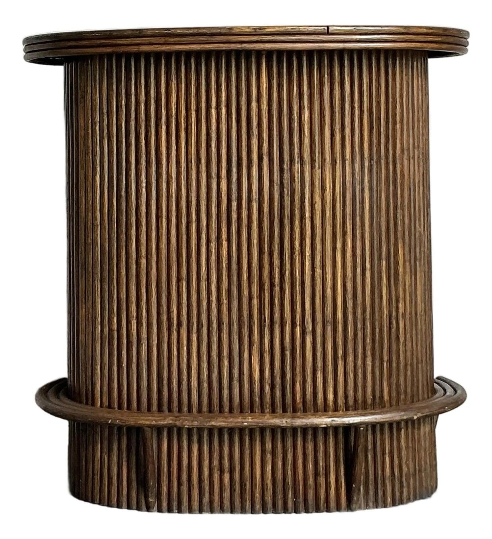 Cylindrical 1970s Rattan Dry Bar With Foot Rail And Shelving: Cylindrical 1970s Rattan Dry Bar With Foot Rail And Shelving This vintage rattan dry bar exemplifies late Mid-Century design with Boho Chic and Tropical influences from the 1970s. Featuring a cylindri
