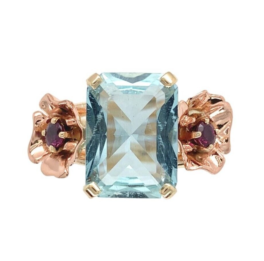 1940s Retro 14k Rose and Yellow Gold Aquamarine Ruby Floral Ring 4.52ct: 1940s Retro 14k Rose and Yellow Gold Aquamarine Ruby Floral Ring 4.52ct This Retro era ring from the 1940s is crafted in 14k rose and yellow gold. It features a rectangular brilliant cut aquamarine we