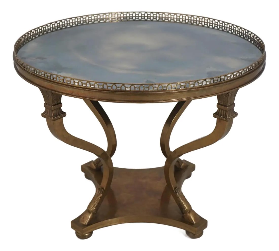 Round Bronze Center Table With Distressed Mirror Top Jansen Inspired Design: Round Bronze Center Table With Distressed Mirror Top Jansen Inspired Design This round center table is crafted in the style of Maison Jansen, featuring a high-quality construction. It has a distressed