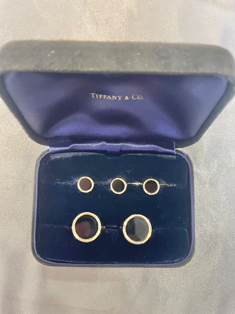 Tiffany & Co 14K Gold Black Onyx Cufflinks and Shirt Studs Set: Tiffany & Co 14K Gold Black Onyx Cufflinks and Shirt Studs Set Elevate your formal attire with this stunning Tiffany & Co. 14K yellow gold and black onyx dress set. This exquisite set includes a pair