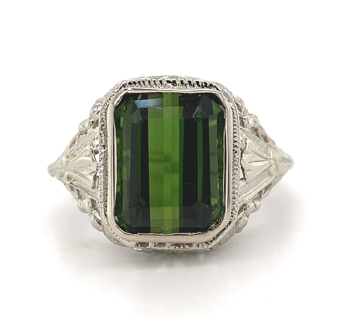 14k White Gold Art Deco Filigree Ring with 4.34ct Green Tourmaline: 14k White Gold Art Deco Filigree Ring with 4.34ct Green Tourmaline This exquisite Art Deco ring, crafted from 14k white gold, features a stunning 4.34ct genuine natural green tourmaline. The emerald-c