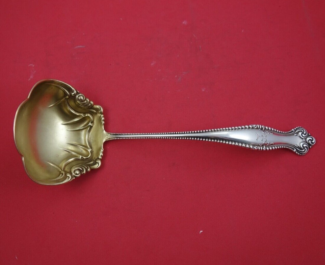 Towle Canterbury Sterling Silver Gold Washed Oyster Ladle 10.5 inches: Towle Canterbury Sterling Silver Gold Washed Oyster Ladle 10.5 inches This elegant Canterbury by Towle oyster ladle showcases a stunning gold-washed finish and a unique lobed design. Crafted from high